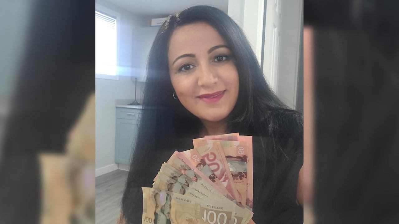 Annie Rawdah tient 1 000 $ trouvés à un guichet automatique