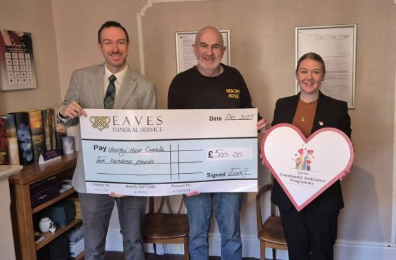 Eaves handing the £500 cheque to Healthy Hopes