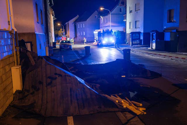 Pompiers devant des maisons endommagées